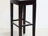 an image of a black and white stool with a white cushion