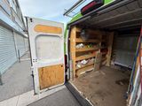 a white van with a door open on the side of the street