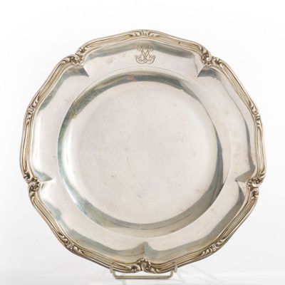 an antique silver plate on a stand on a white background