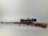 a rifle with a scope mounted on the side of it