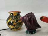 three vases that are sitting next to each other on a table