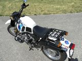 a motorcycle that is parked on the street in the parking lot