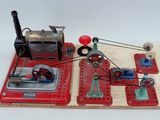a model of a steam engine on a wooden board