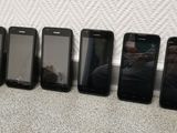 several cell phones are lined up in a row on the floor