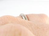 a close up of a person ' s hand with a ring on it