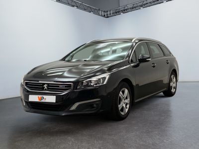 the black car is parked in a large room with white walls