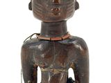 an image of a wooden statue of a man with a flower in his hand