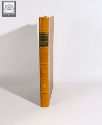 an old book sitting on top of a white table next to a white wall