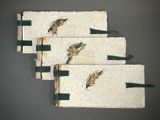 three white towels with birds on them are hanging on a wall