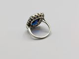 a close up of a ring with a blue stone in it