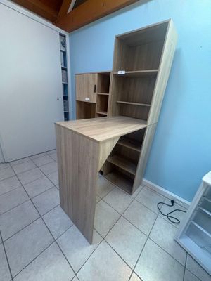 an image of a room with a desk and shelves