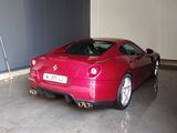 a red sports car parked inside of a garage