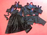 three pieces of black clothing on a red surface