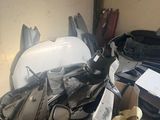 a motorcycle that is sitting in a box in the garage