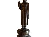 bronze statue of a standing buddha on a pedestal with a white background
