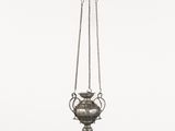 a silver vase hanging from a chain on a white background