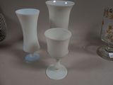 three vases sitting on a table next to each other