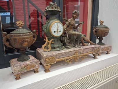 une horloge posée sur une table, à côté d'autres objets
