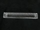 a close up of a clear glass object on a black surface