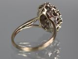 a close up of a ring with a diamond center
