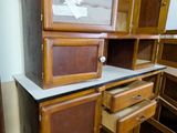 a cabinet with a mirror on top of it in a room