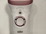 a white and pink electric shaver on a white table