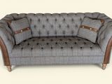 an image of a gray couch with buttons on it