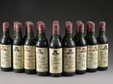 six bottles of wine are lined up in a row on a table