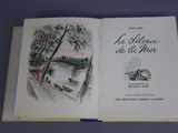 an open book with a picture of a boat in the water