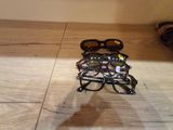 a pair of glasses sitting on the floor next to a pair of shoes