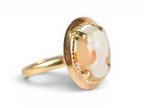 an image of a gold ring with a shell in the center