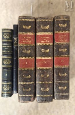 three old books sitting on top of a table next to each other