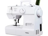 a white sewing machine with a spool of thread on it
