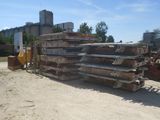 a large pile of metal on the ground in front of a building