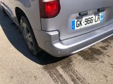 a silver van that is parked on the side of the road