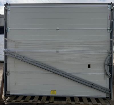a large white box sitting on a pallet in a parking lot