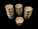 six silver cups are arranged in a circle on a black background