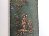 a small box with a painting of a woman on it