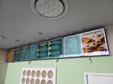 a menu on the wall of a restaurant with a lot of menus