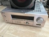 a silver stereo system with a speaker on top of it