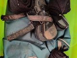 a green bin filled with clothes and a pair of shoes