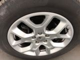 the tire of a car with a flat tire on the ground