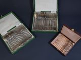 a box of silverware sitting on a table next to a box of silverware