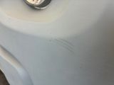 a close up of a car ' s headlight on a white car