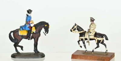 two figurines of a man on a horse and a man on a horse