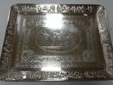 a silver plate with a picture of a man on a horse