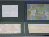 three cards with different designs on them sitting on a table