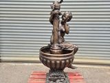 a statue of a woman sitting in a bowl on a pallet