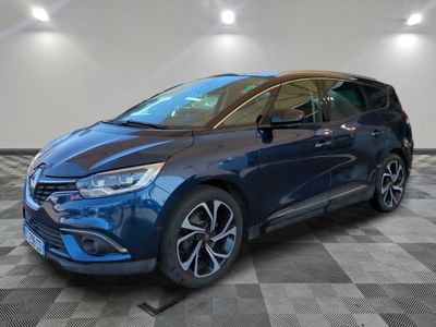 a blue car is parked on a checkered floor in a garage