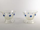 pair of blue and clear glass cups with polka dots on them